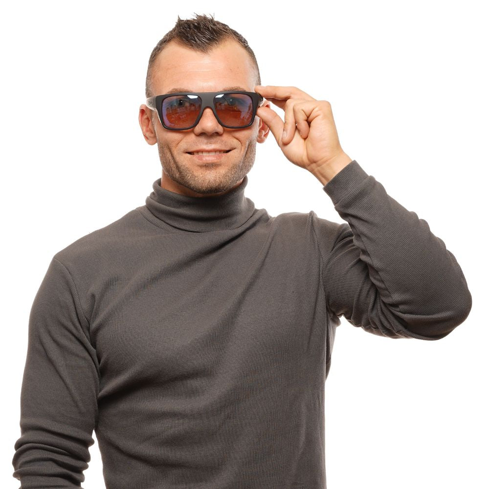 Person wearing Bolle Black Unisex Sunglasses with brown polarized lenses and full-rim plastic frame.