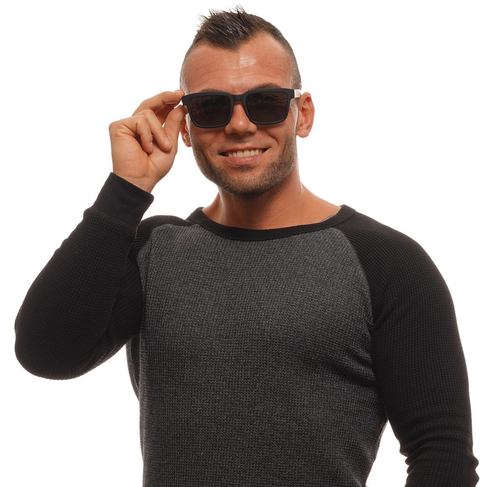 Man wearing Spy Black Unisex Sunglasses with polarized grey lenses and black plastic frame.