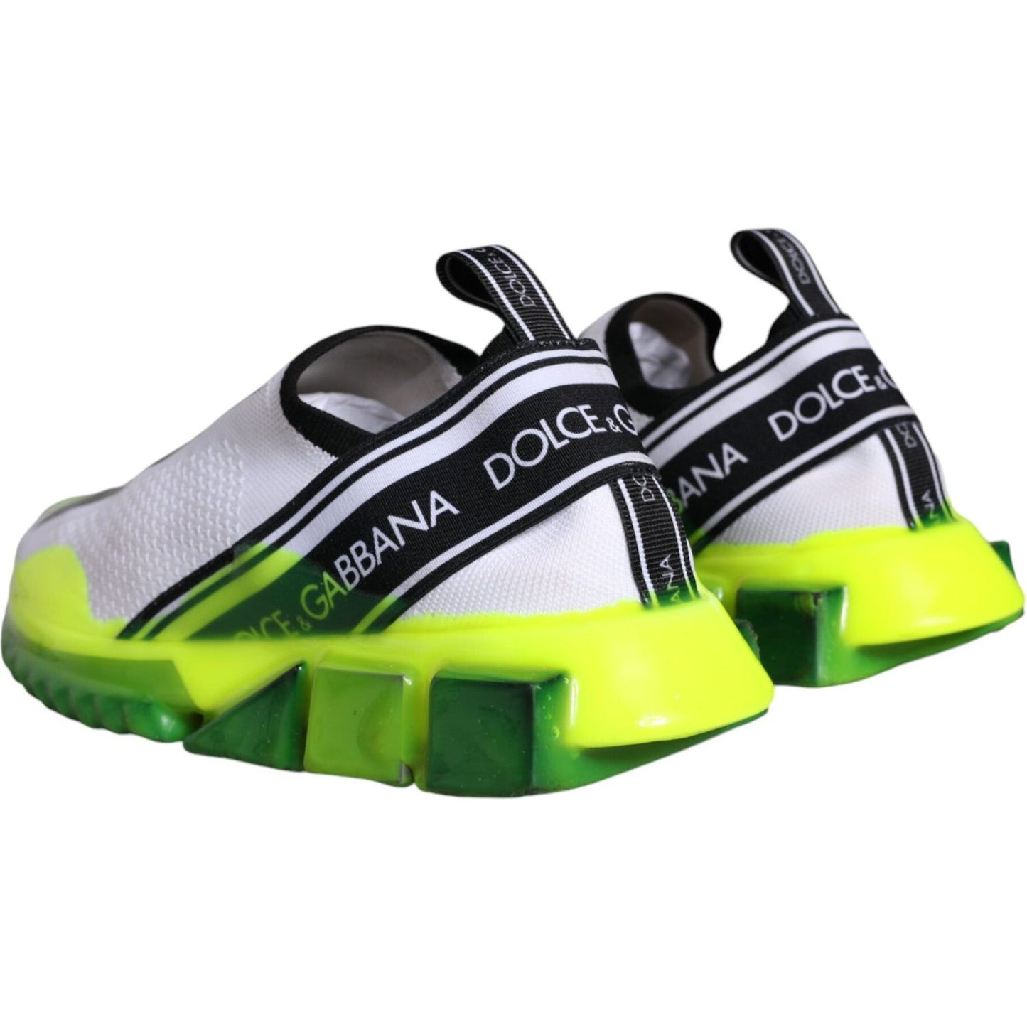 Dolce & Gabbana Sorrento sneakers in white and yellow with black logo bands and decorative rubber soles, back view.