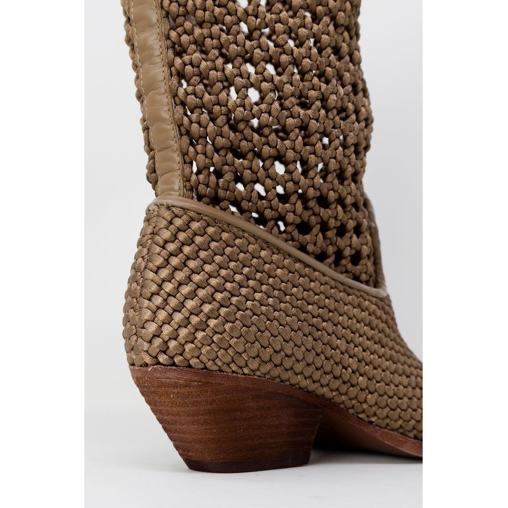 Close-up of woven beige leather women's boot with wooden heel from the spring/summer collection, emphasizing detailed craftsmanship.