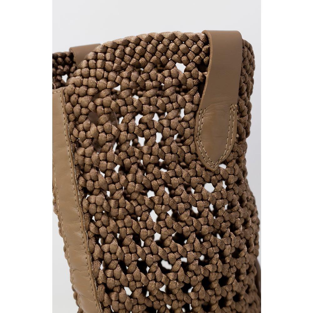 Close-up of a woven textured brown boot, showcasing intricate design and leather accents.