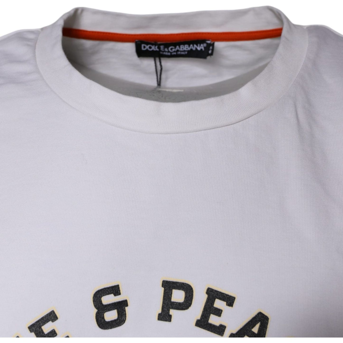 Dolce & Gabbana white cotton t-shirt with round neck, featuring 'Love & Peace' text and logo detail, showing minor discolorations.