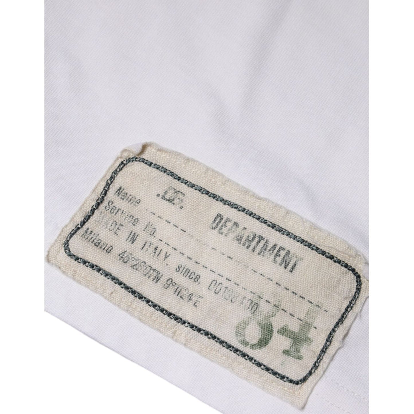 Label on Dolce & Gabbana white cotton T-shirt with Made in Italy details and minor discoloration.