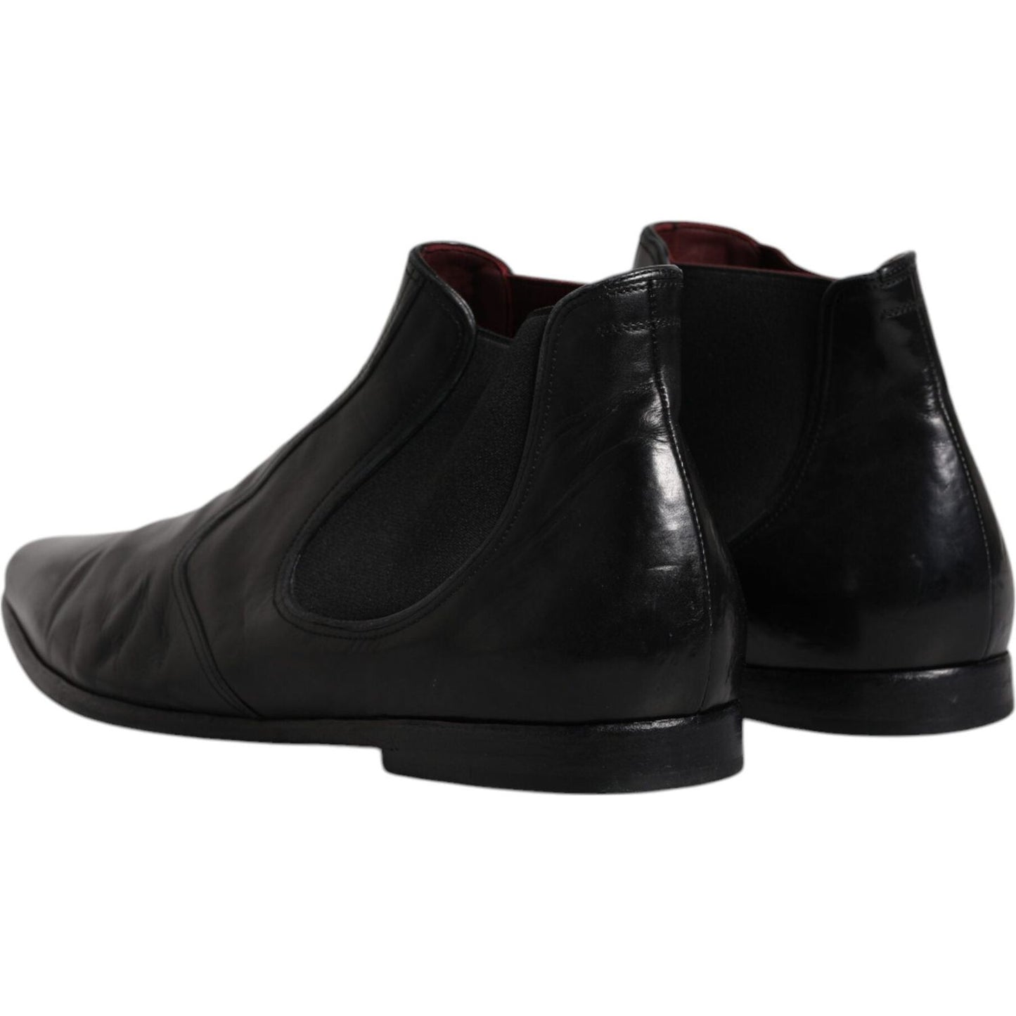 Dolce & Gabbana black leather Chelsea men's ankle boots with stretch bands and logo details, view of heel and sole.