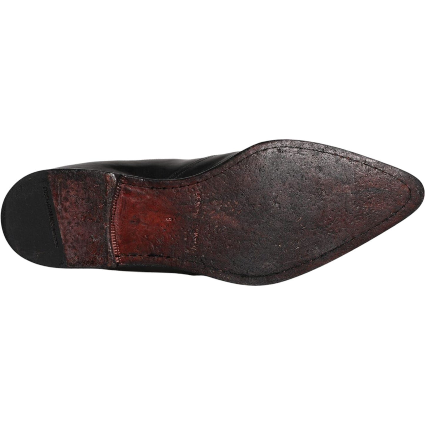 Sole of Dolce & Gabbana black leather Chelsea men's ankle boots showing wear and high craftsmanship, made in Italy.