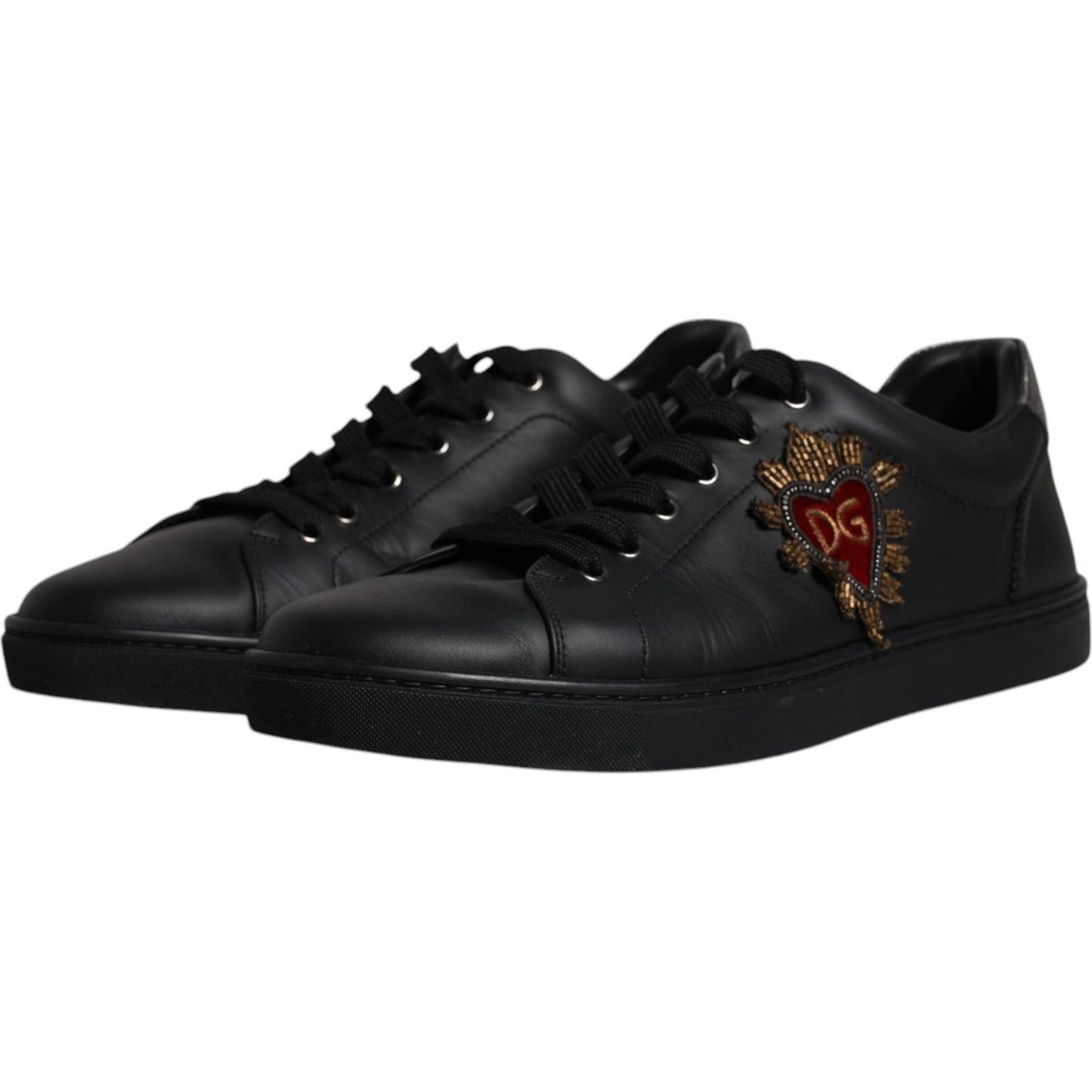 Dolce & Gabbana black leather low-top sneakers with red heart and gold accents, lace-up closure, rubber sole, minor logo defect.