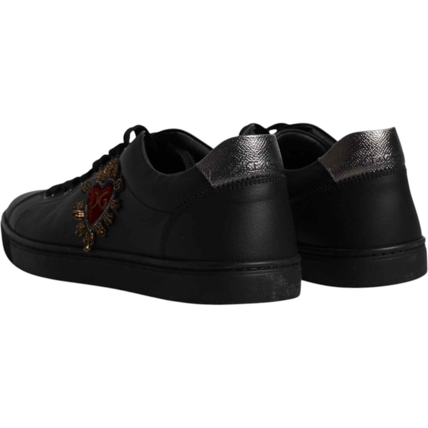 Dolce & Gabbana black leather sneakers with red heart design and logo detail, showing minor logo defect. Made in Italy, men's footwear.