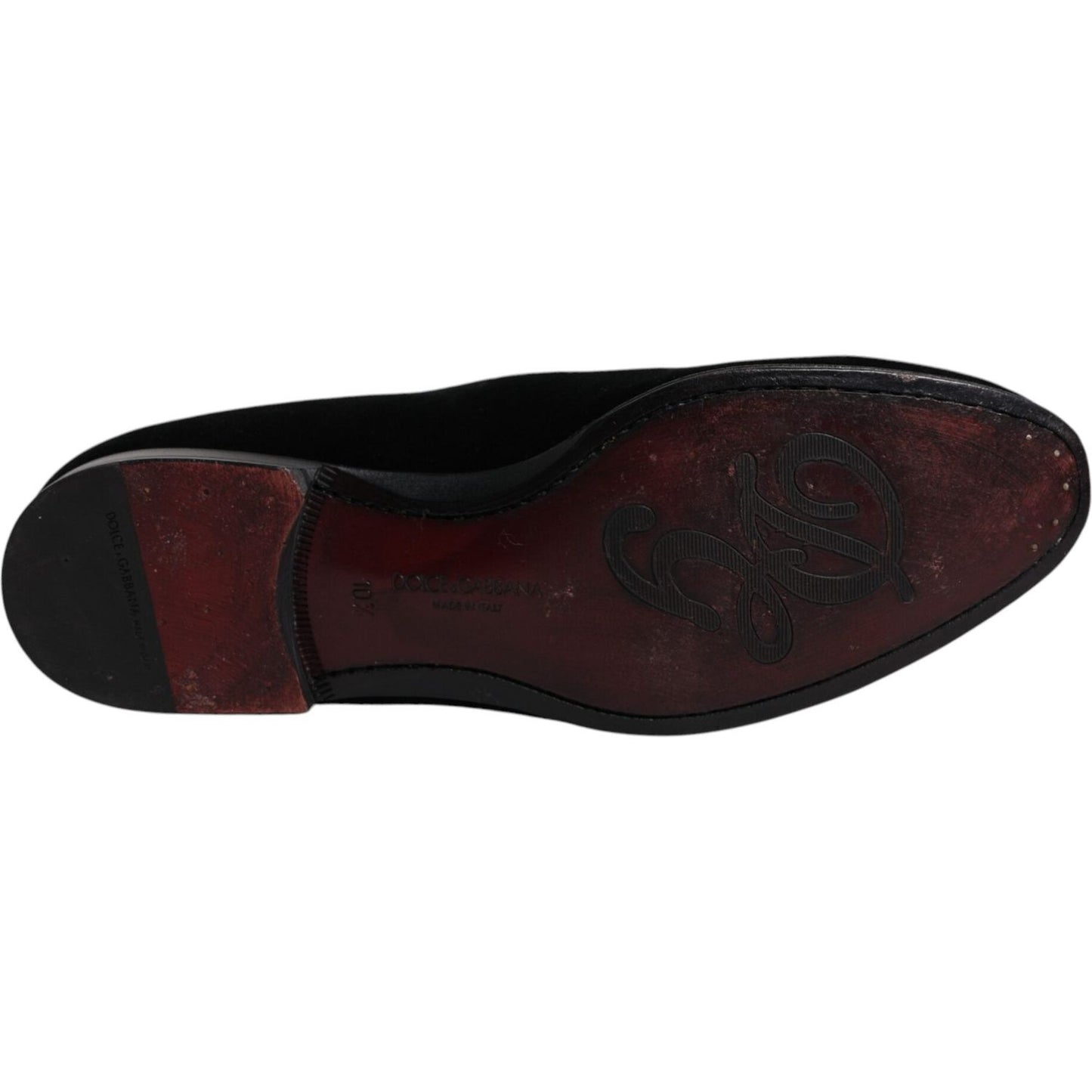 Undersole view of Dolce & Gabbana black velvet loafers for men, showcasing leather craftsmanship and brand logo.