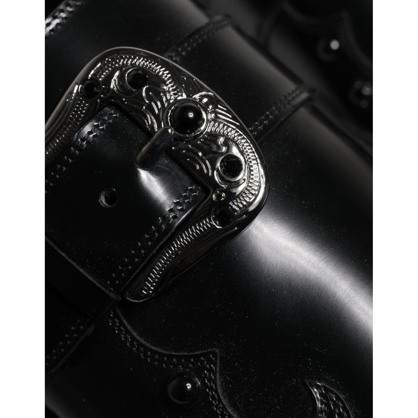 Close-up of Dolce & Gabbana black embellished derby monk strap shoe buckle, 100% calf leather, elegant design, Italian craftsmanship.