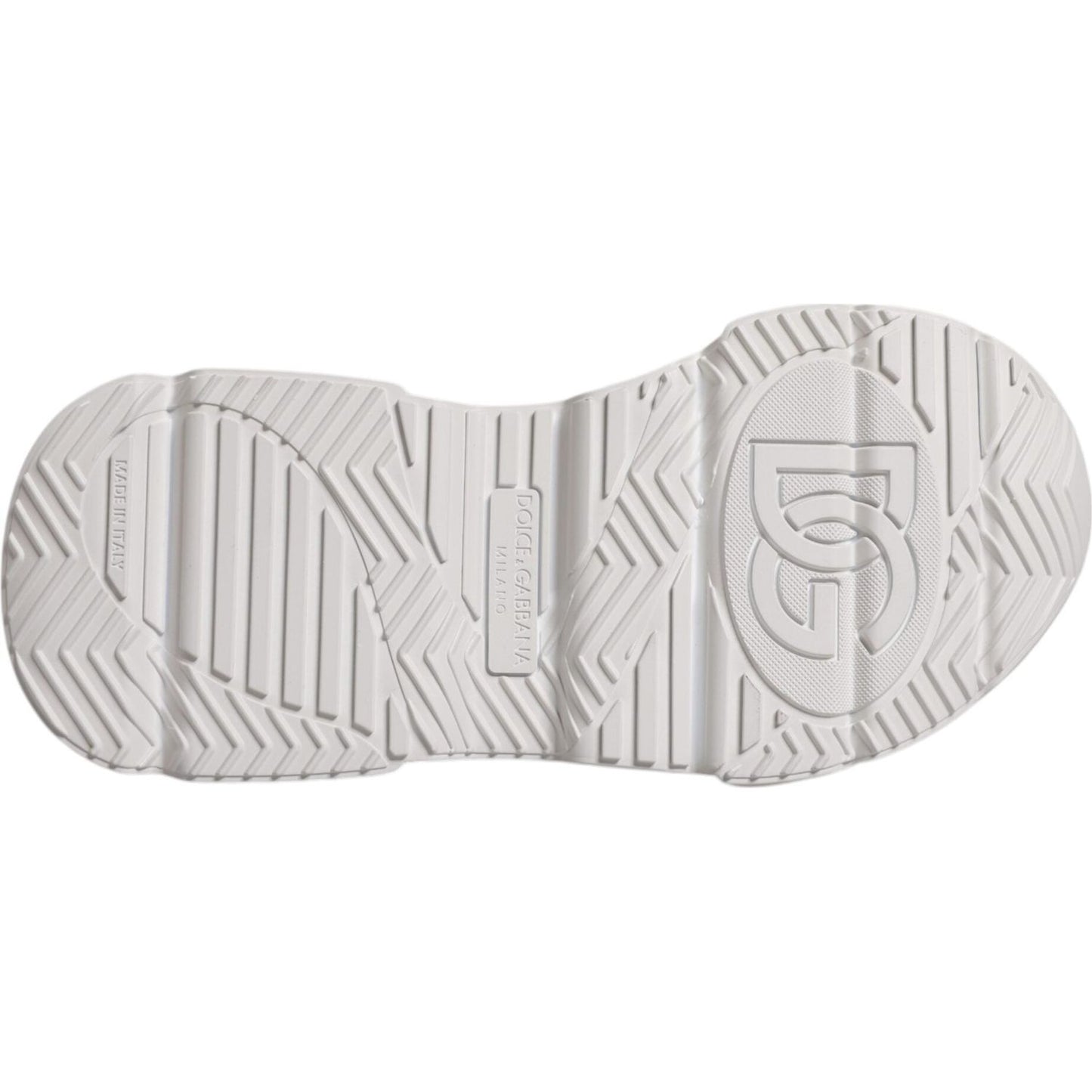 Sole view of Dolce & Gabbana Daymaster white sneakers with rubber tread pattern. Authentic luxury shoes with minor discolorations.