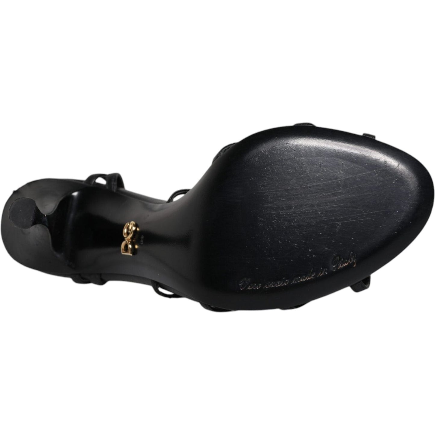 Bottom view of Dolce & Gabbana black leather Keira sandals showing sole and logo details, with visible scratches.