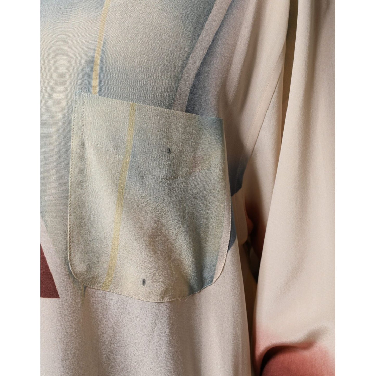 Close-up of Etro beige printed collared silk blouse with pocket detail and minor front stain.