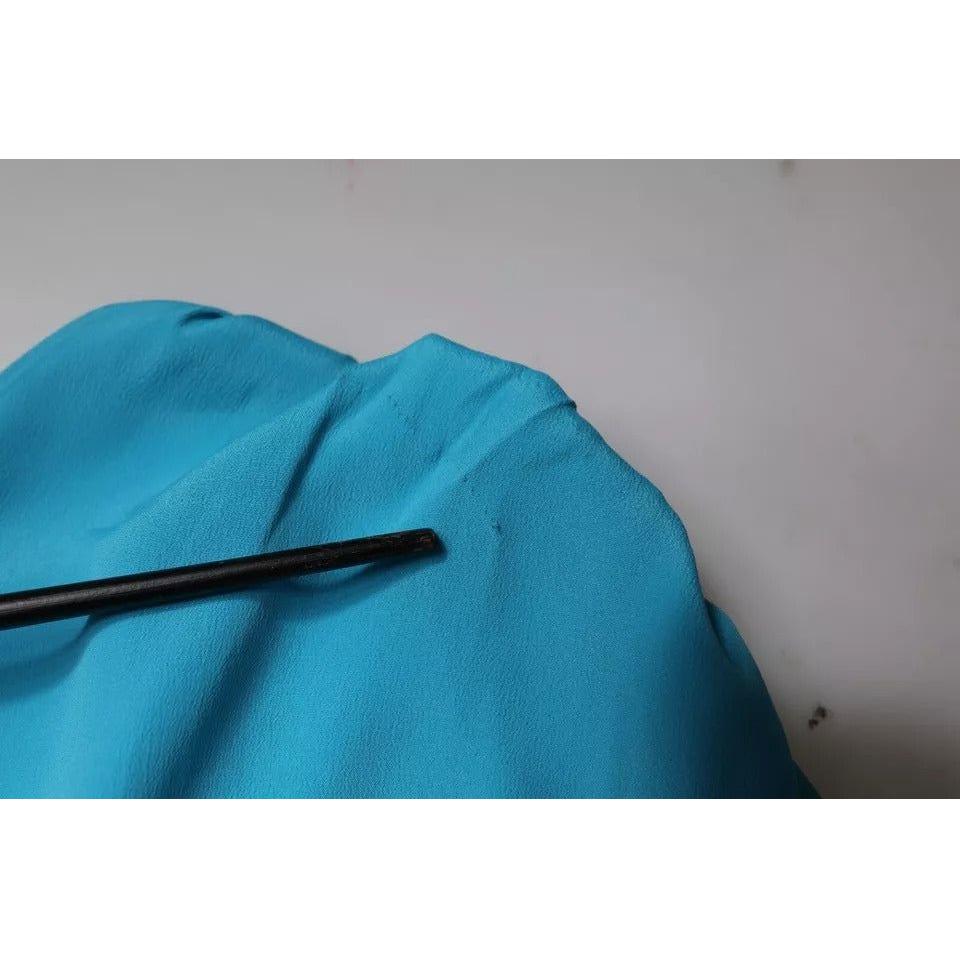 Close-up of Boutique Moschino blue blouse showing pulled threads and minor defects.
