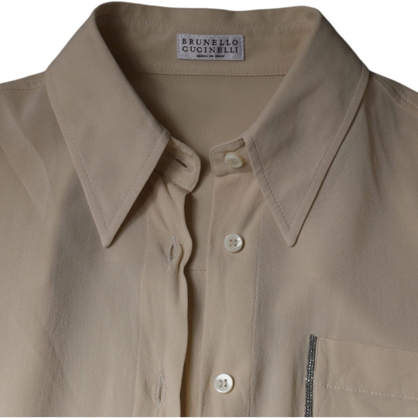 Brunello Cucinelli beige silk blend button-down top with collar and chest pocket, featuring button closure and luxurious design.