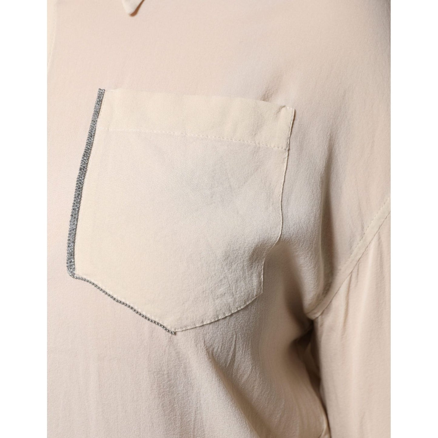 Close-up of Brunello Cucinelli beige silk blend button-down top with chest pocket and detailed stitching.