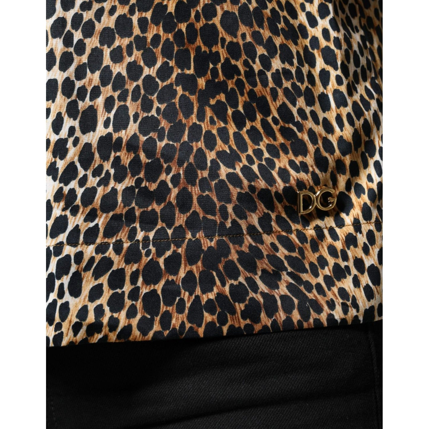 Dolce & Gabbana brown leopard print blouse with logo detail, cotton blend, close-up showing fabric texture.
