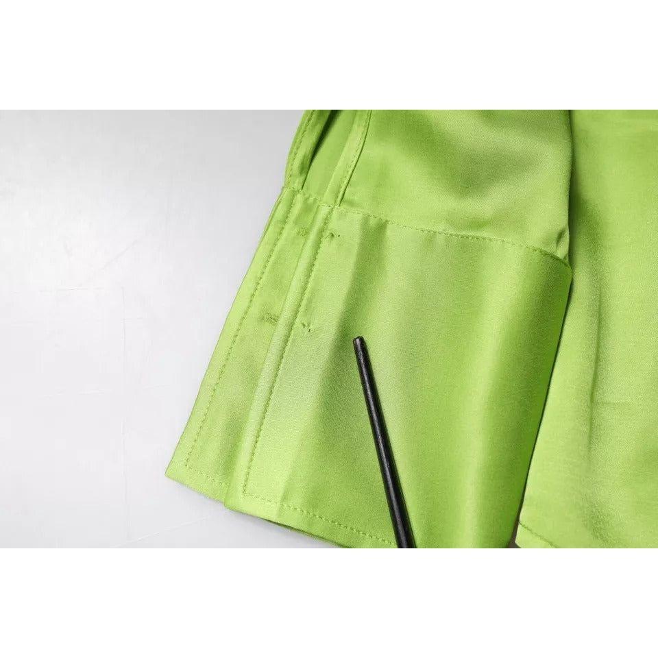 Close-up of green viscose Patrizia Pepe blouse showing missing button on sleeve against white background.
