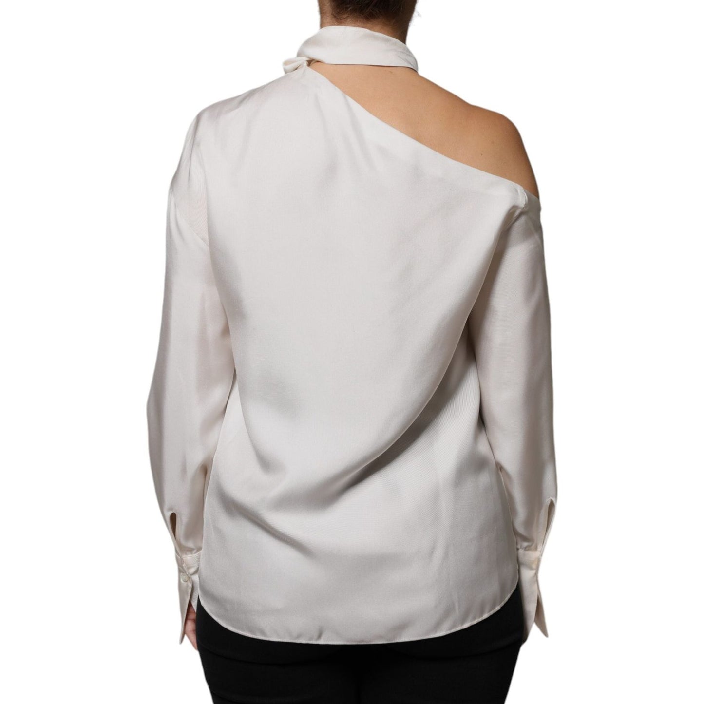 Back view of Brunello Cucinelli beige silk long-sleeve top with ascot collar and minor defects, showcasing buttoned cuffs and elegant design.