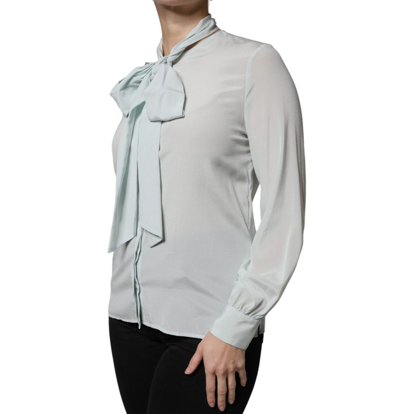 Light blue silk ascot collared long sleeve top by Ballantyne with front button closure, worn by a model, showcasing a feminine style.