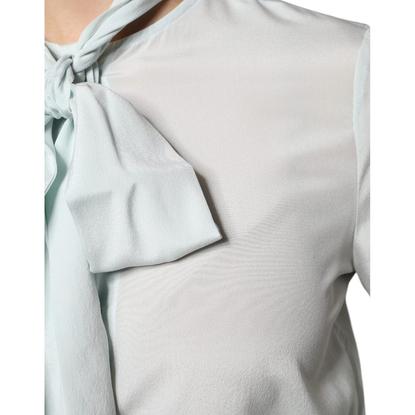 Light blue silk ascot collared long sleeve Ballantyne top with button closure, showing logo detail and fabric texture.