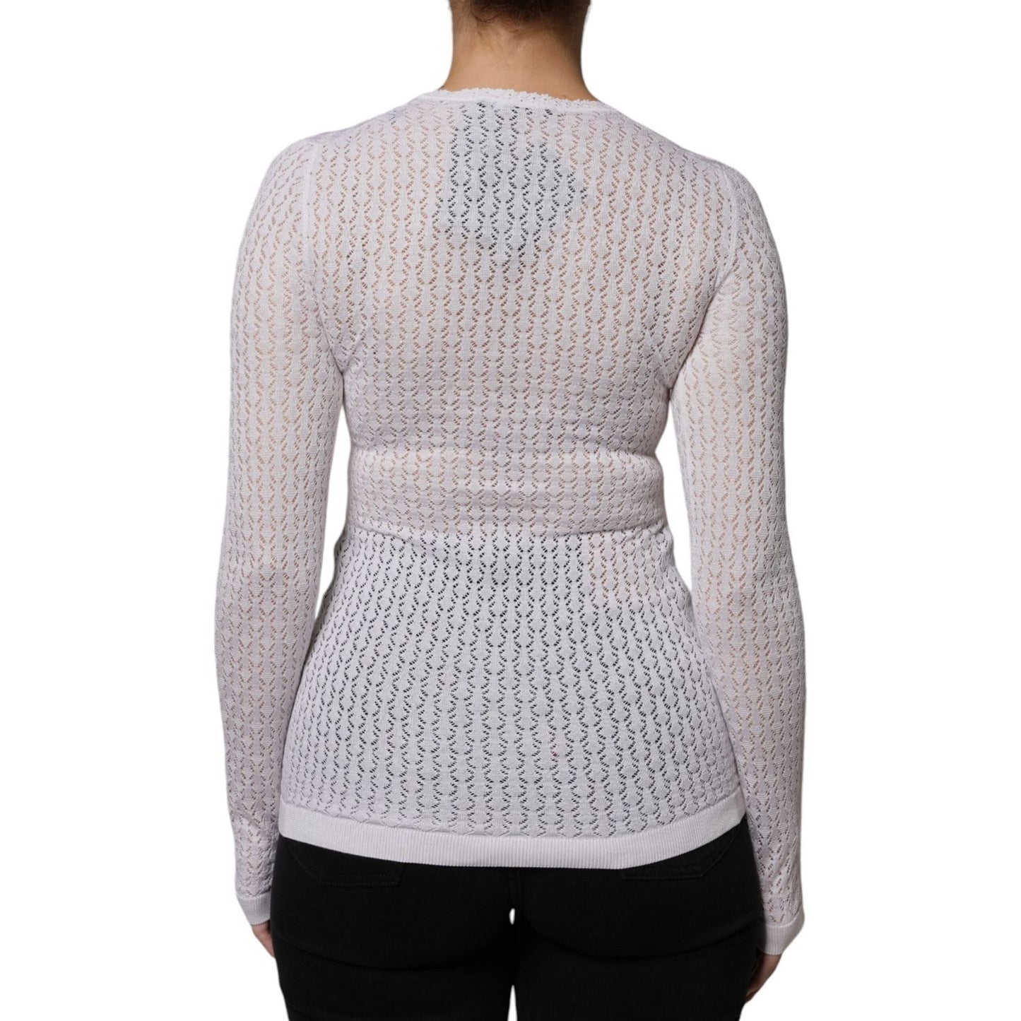 Back view of white Dolce & Gabbana silk cardigan sweater featuring button-down design, exclusive craftsmanship, minor stain visible.