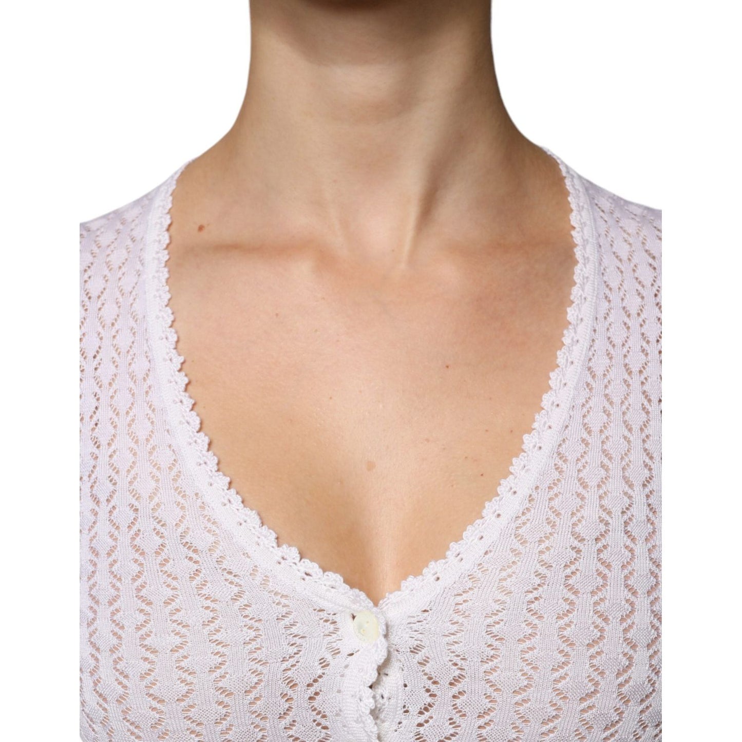 Close-up of Dolce & Gabbana white silk button down cardigan sweater, featuring a delicate knit pattern and V-neck design.