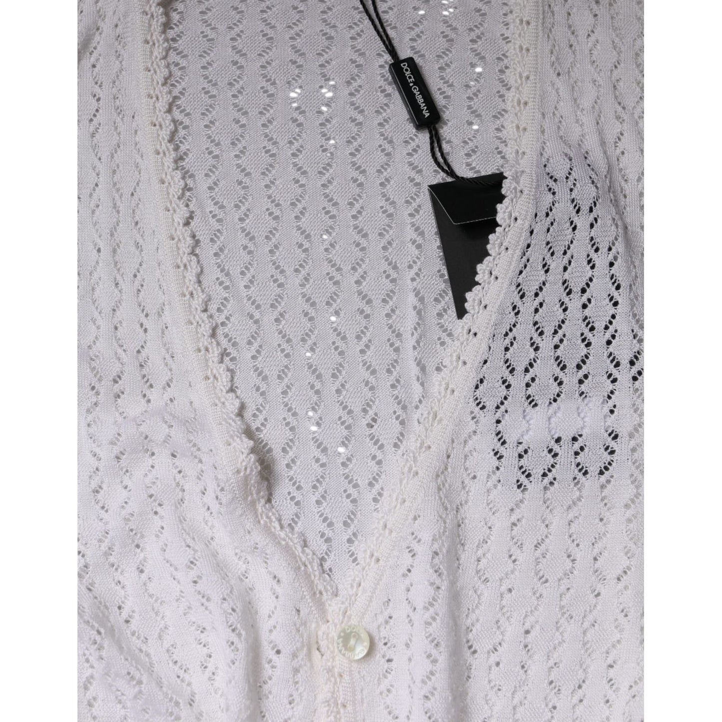 Dolce & Gabbana white silk button down cardigan sweater with v-neck and logo tag, showcasing intricate knit pattern.
