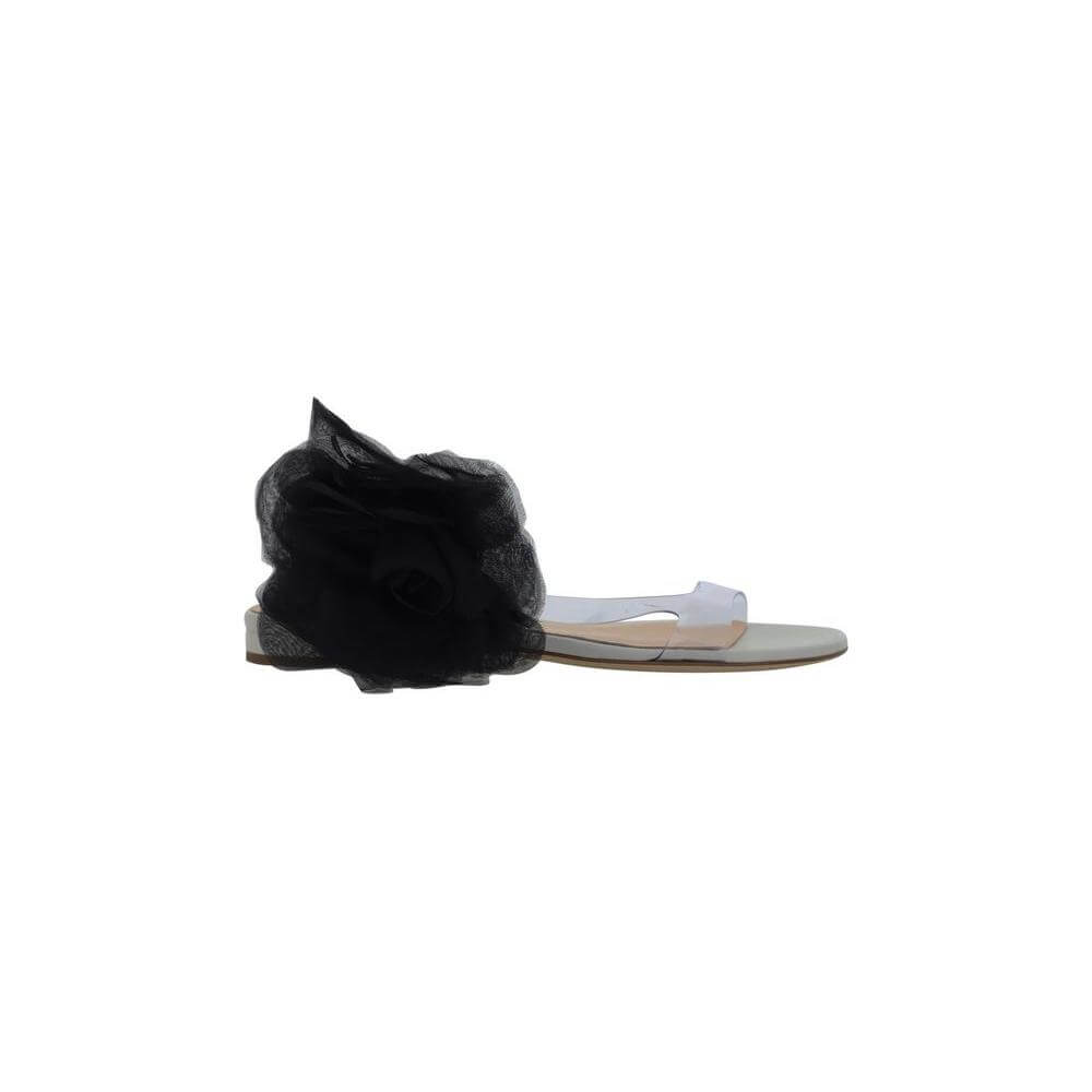 Magda Butrym sandals with transparent PVC design and black maxi flower appliqué, featuring a flat leather sole and logo-embossed insole.