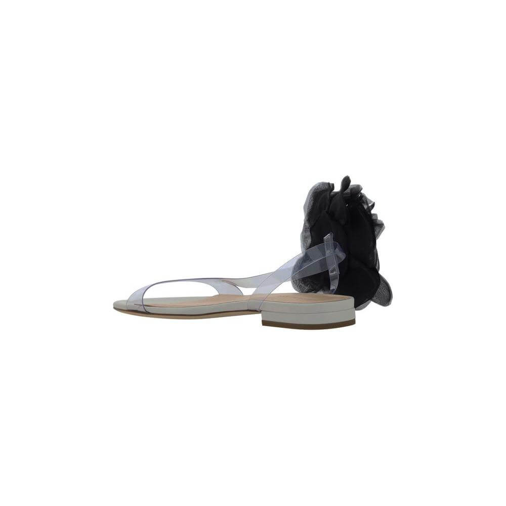 Magda Butrym sandals with transparent PVC design, black flower appliqué, flat leather sole, and logo-embossed insole.