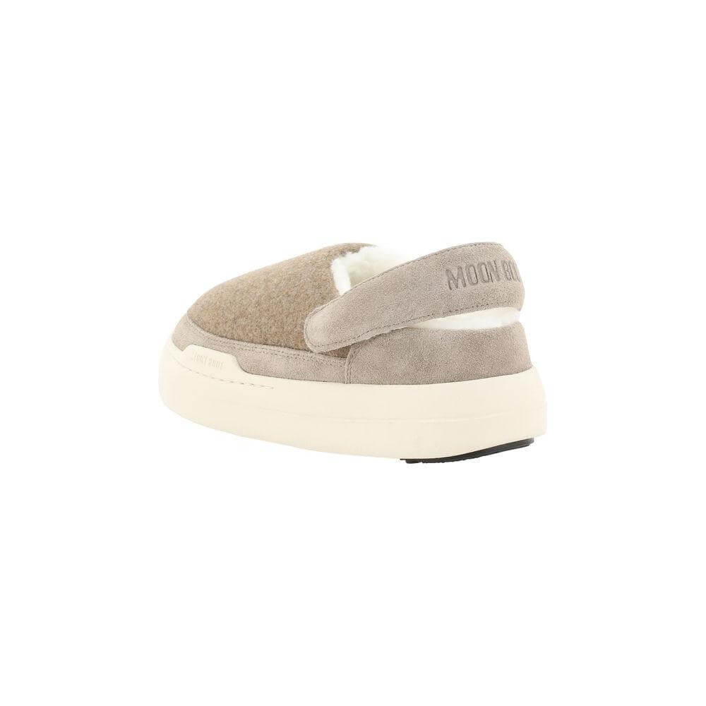 Moon Boot Mules with suede detailing, shearling interior, and iconic brand monogram on slingback. Non-slip textured sole.