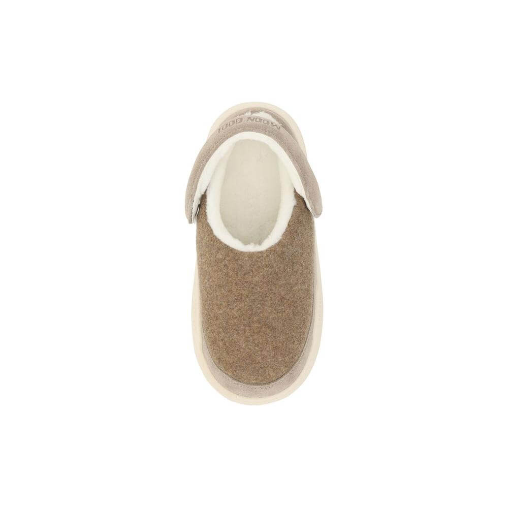 Top view of Moon Boot Mules with round toe, suede detailing, shearling interior, and slingback with monogram print.