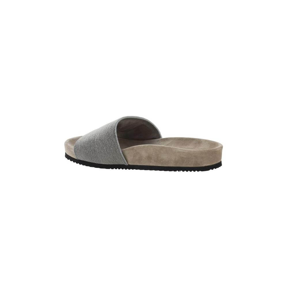 Brunello Cucinelli flat sandals with wide jeweled band, suede sole, and logo insole, side view.