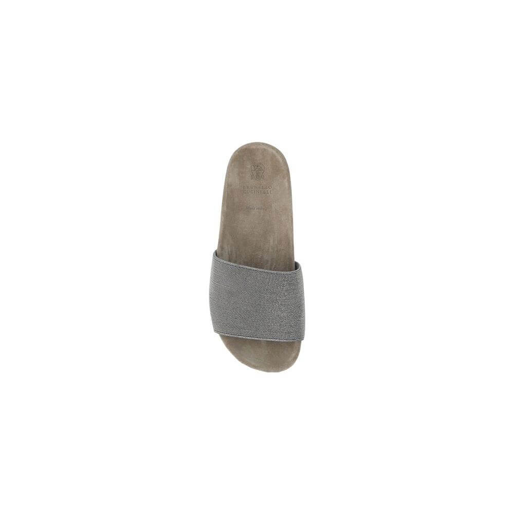 Top view of Brunello Cucinelli sandal with flat sole, round toe, jewel-covered band, and suede design, featuring logo insole.