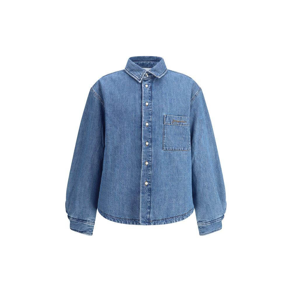 Jacquemus La Chemise Boulanger Shirt Jacket in denim with classic collar, front button closure, monogrammed pocket, and quilted interior.