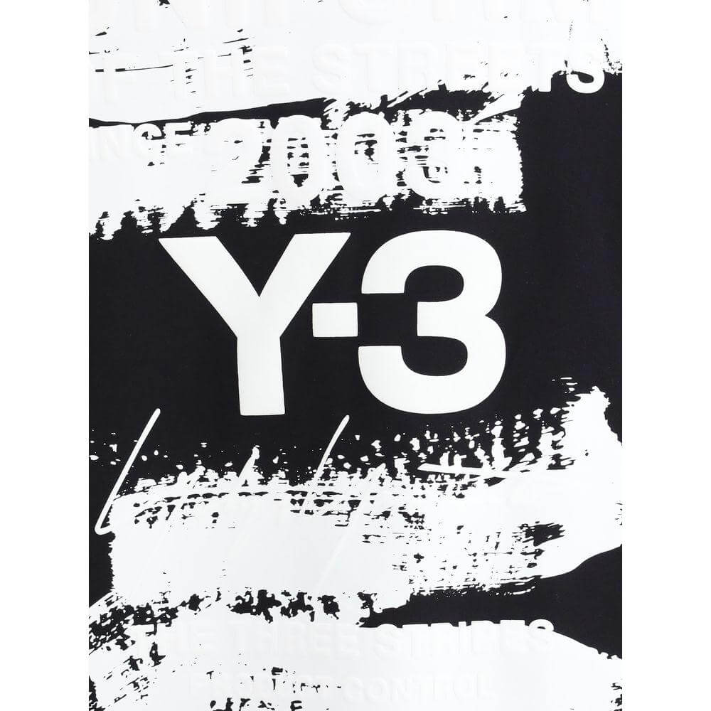 Close-up of Y-3 long sleeve jersey with bold contrasting maxi print and iconic monogram on black and white background.