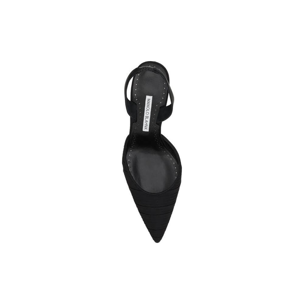 Top view of Manolo Blahnik Carolyne black silk satin pump with pleated design, elongated toe, and elastic slingback
