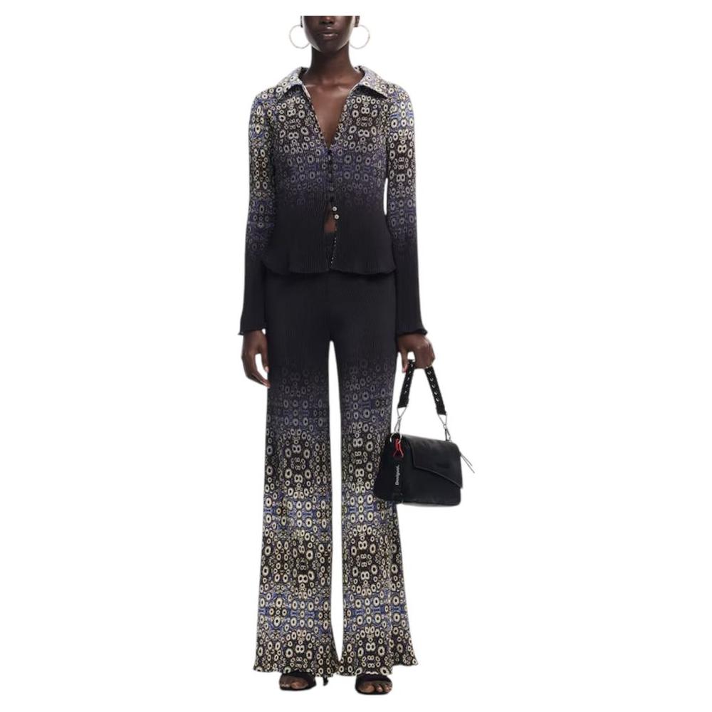 Model holding a Desigual black polyethylene handbag, wearing a floral patterned outfit, showcasing spring/summer fashion.
