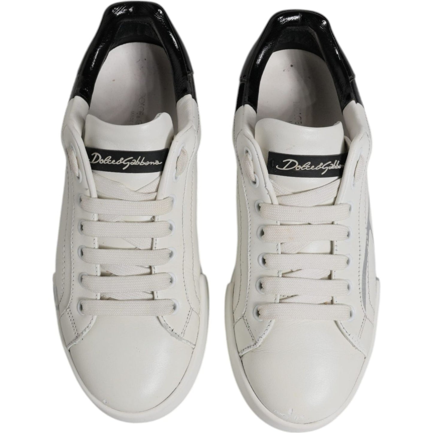 Dolce & Gabbana Portofino sneakers, white and black leather with lace-up design, round toes, and logo detail on tongue.