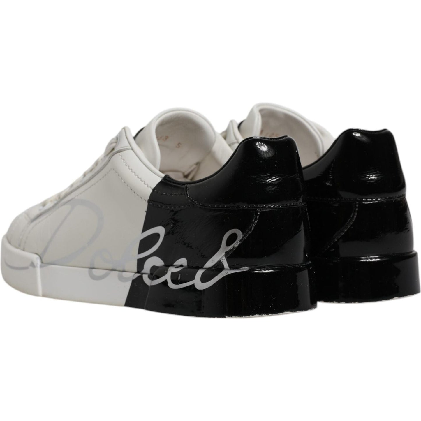 Dolce & Gabbana Portofino sneakers in white and black calfskin leather with logo detail, lace-up design, and rubber soles.