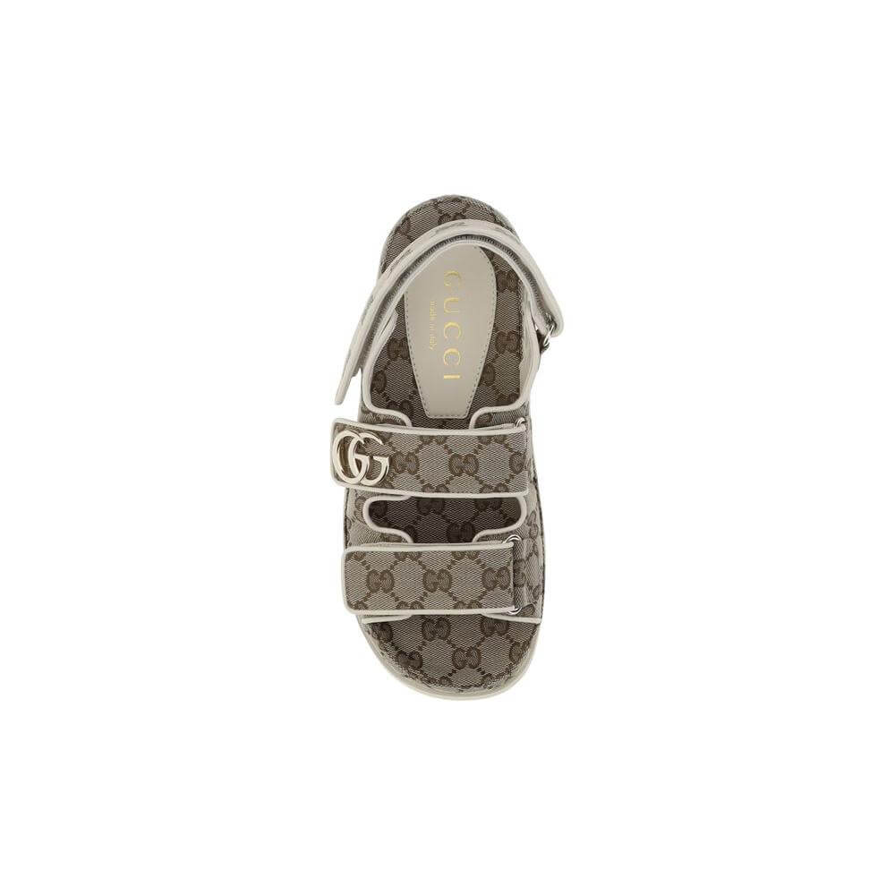 Gucci GG pattern sandal with high rubber sole and logo plaque, featuring adjustable front straps and Velcro closure for comfort and style.