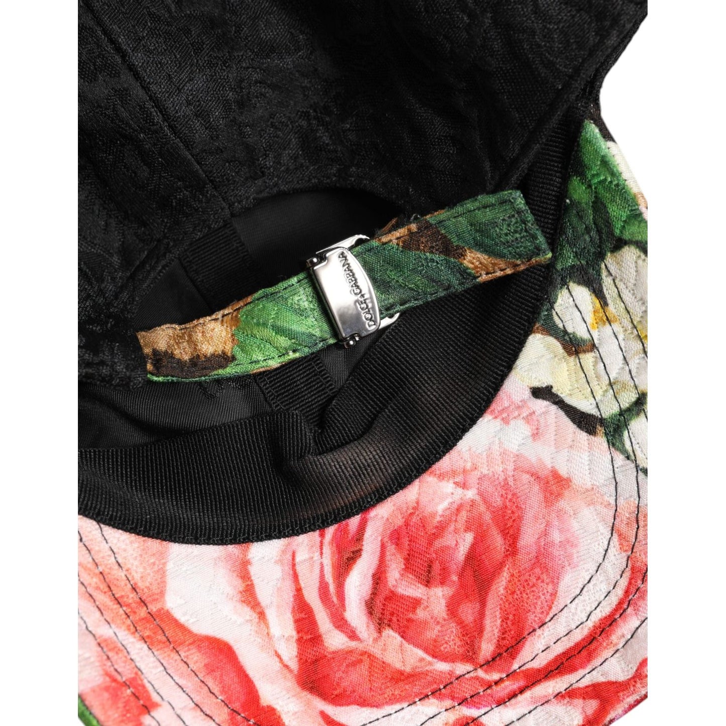 Interior view of Dolce & Gabbana multicolor baseball cap with floral pattern and adjustable strap, showcasing brand logo detail.