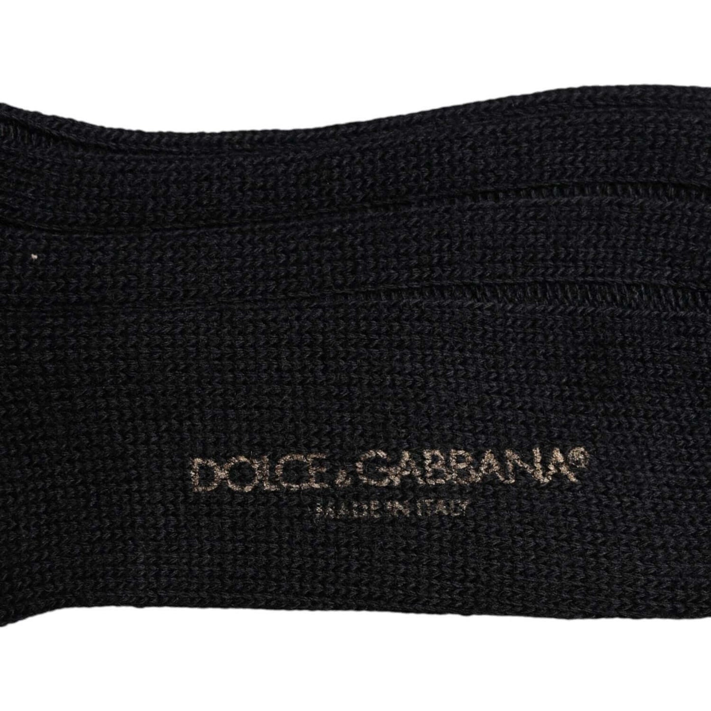 Dolce & Gabbana black over the calf socks with logo print, made in Italy, composed of wool, nylon, and elastane for men.