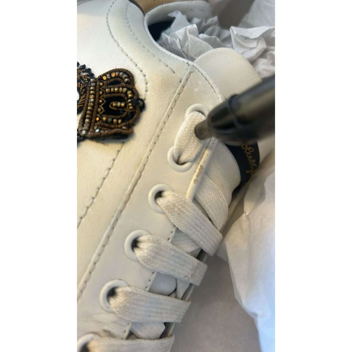 Dolce & Gabbana white Portofino sneaker with crown patch, lacing detail, luxury craftsmanship, white gold-tone leather, Italian-made.