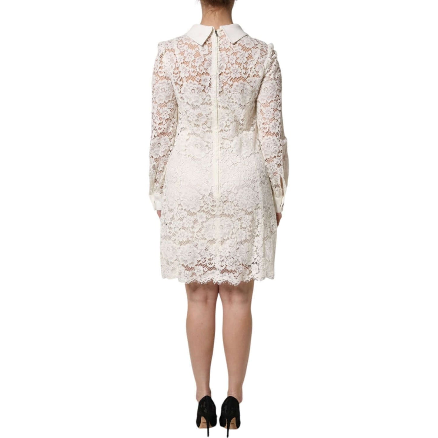 Back view of Dolce & Gabbana white floral lace shift dress with long sleeves, showcasing intricate design and zipper closure.