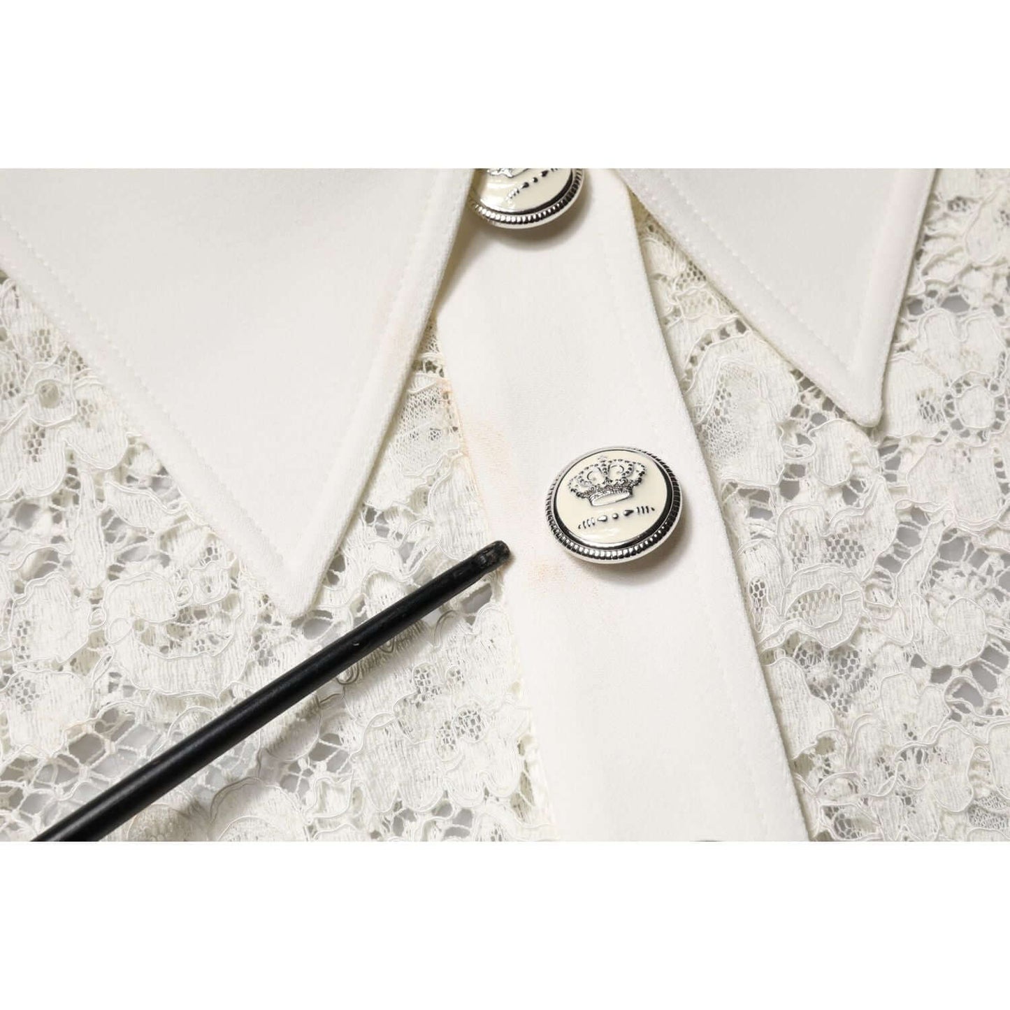 Close-up of Dolce & Gabbana white floral lace fabric with button detail and minor makeup stain on shift dress.