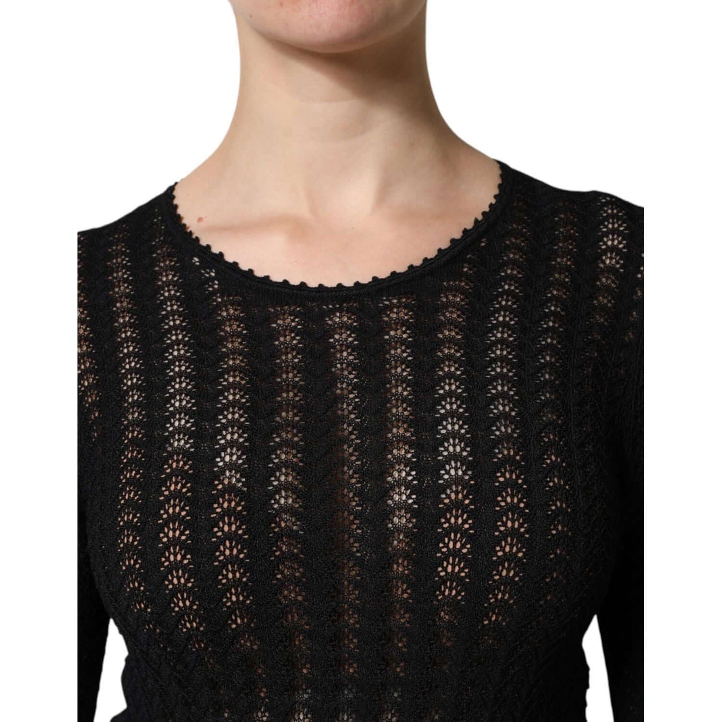 Close-up of a black lace long sleeve top with intricate patterns.