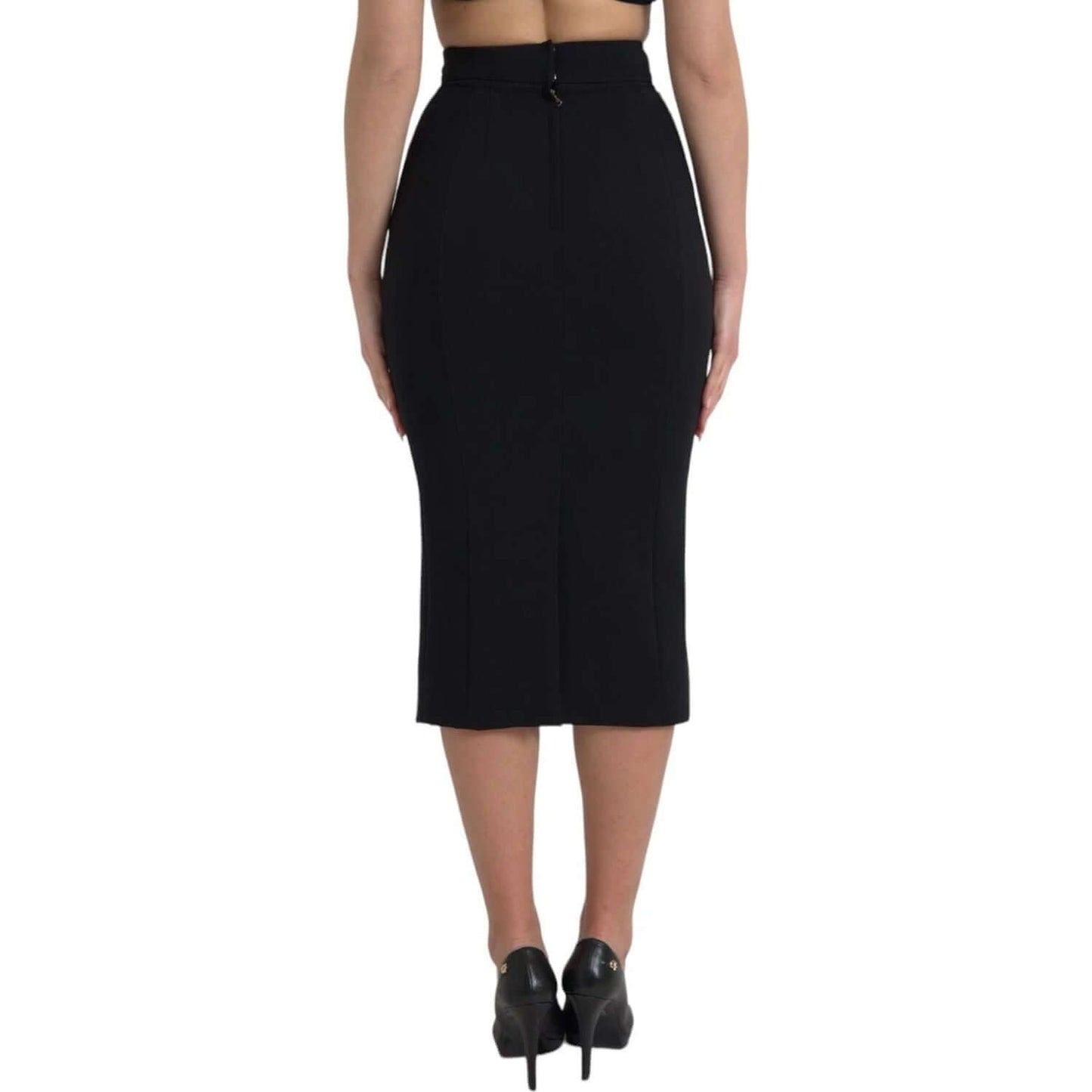 Back view of Dolce & Gabbana black wool high waist pencil cut midi skirt with back zipper closure, modeled against a white background.