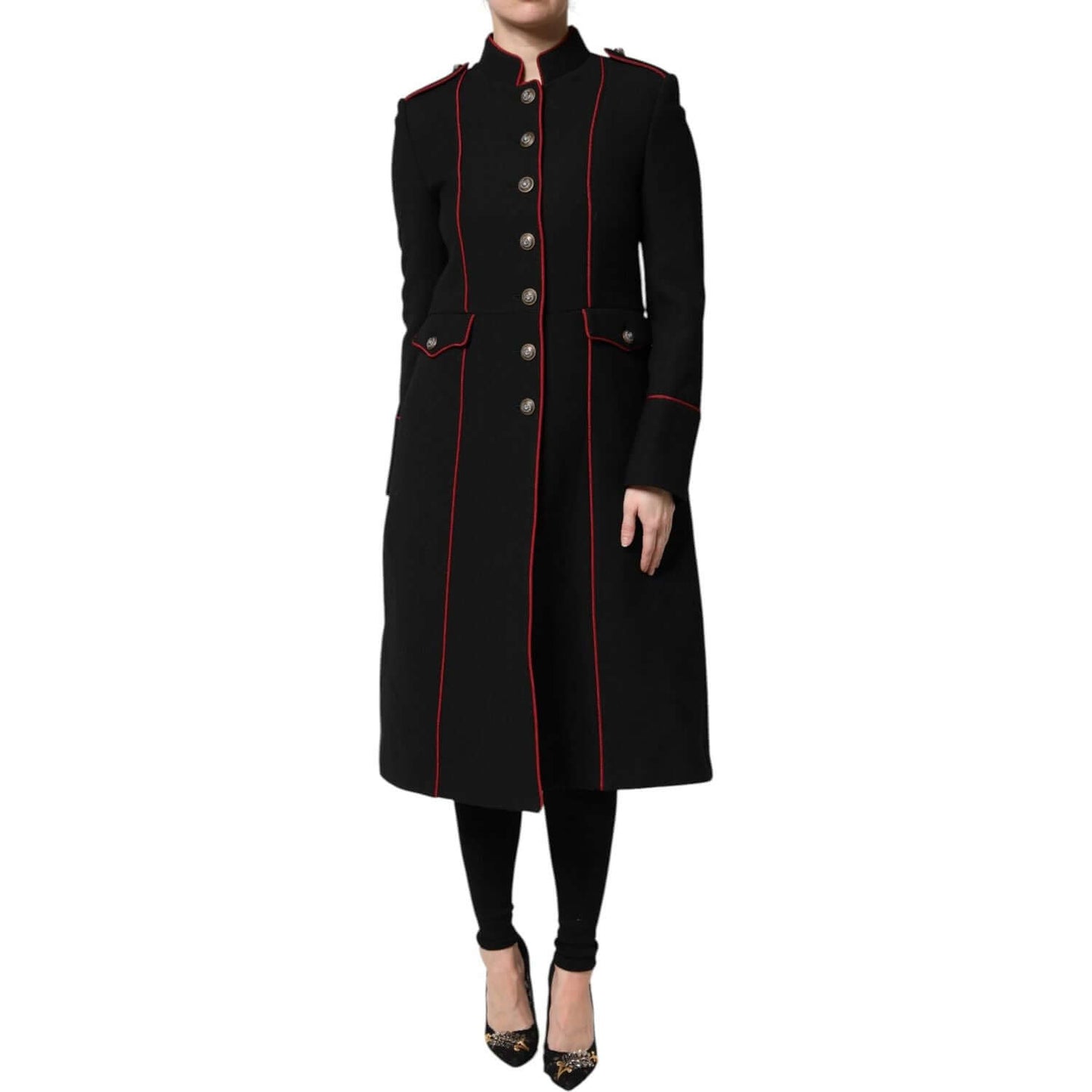 Dolce & Gabbana black wool trench coat jacket with button closure and red piping, worn by standing model, luxury fashion.