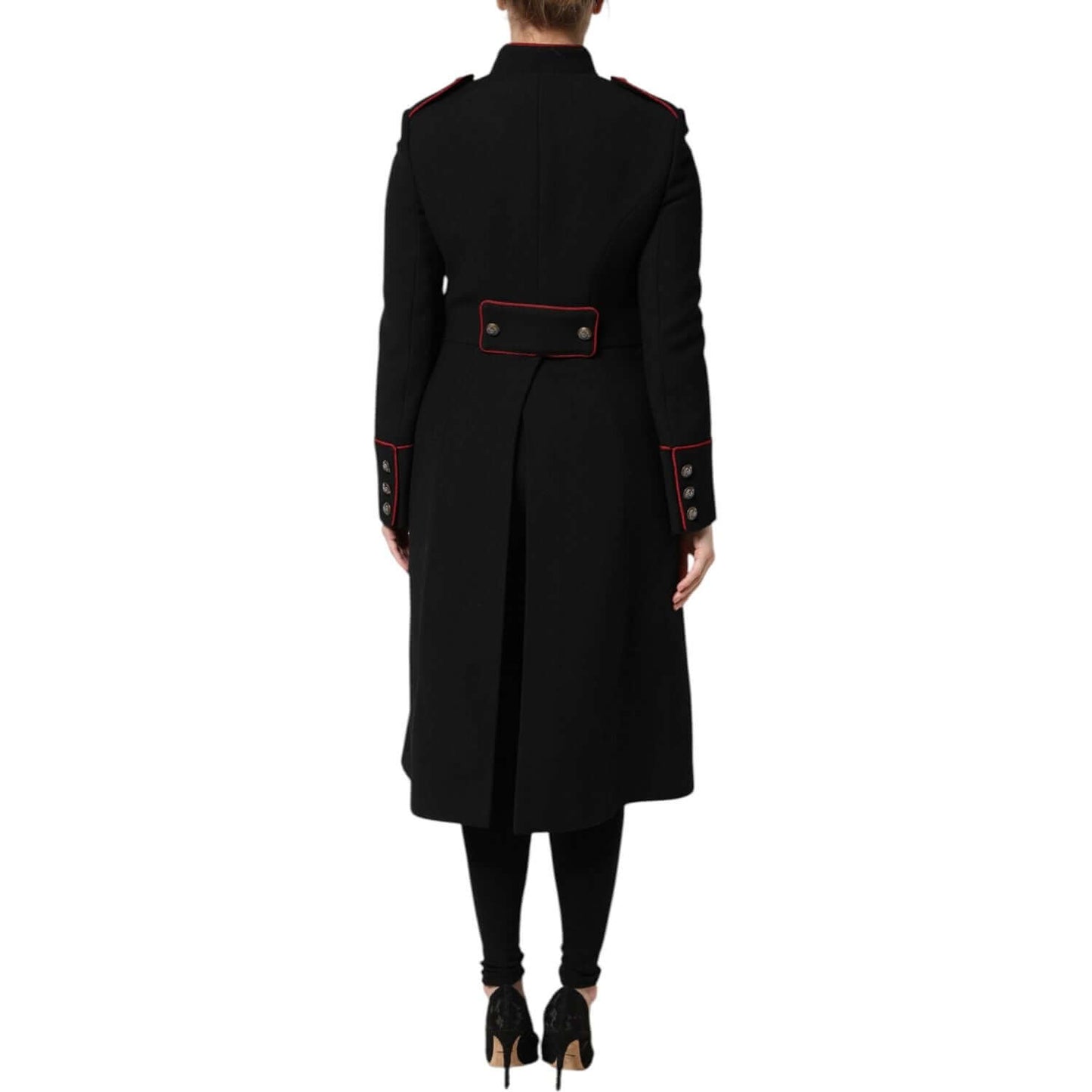 Back view of Dolce & Gabbana black wool trench coat with button details and red accents, model wearing heels and leggings.