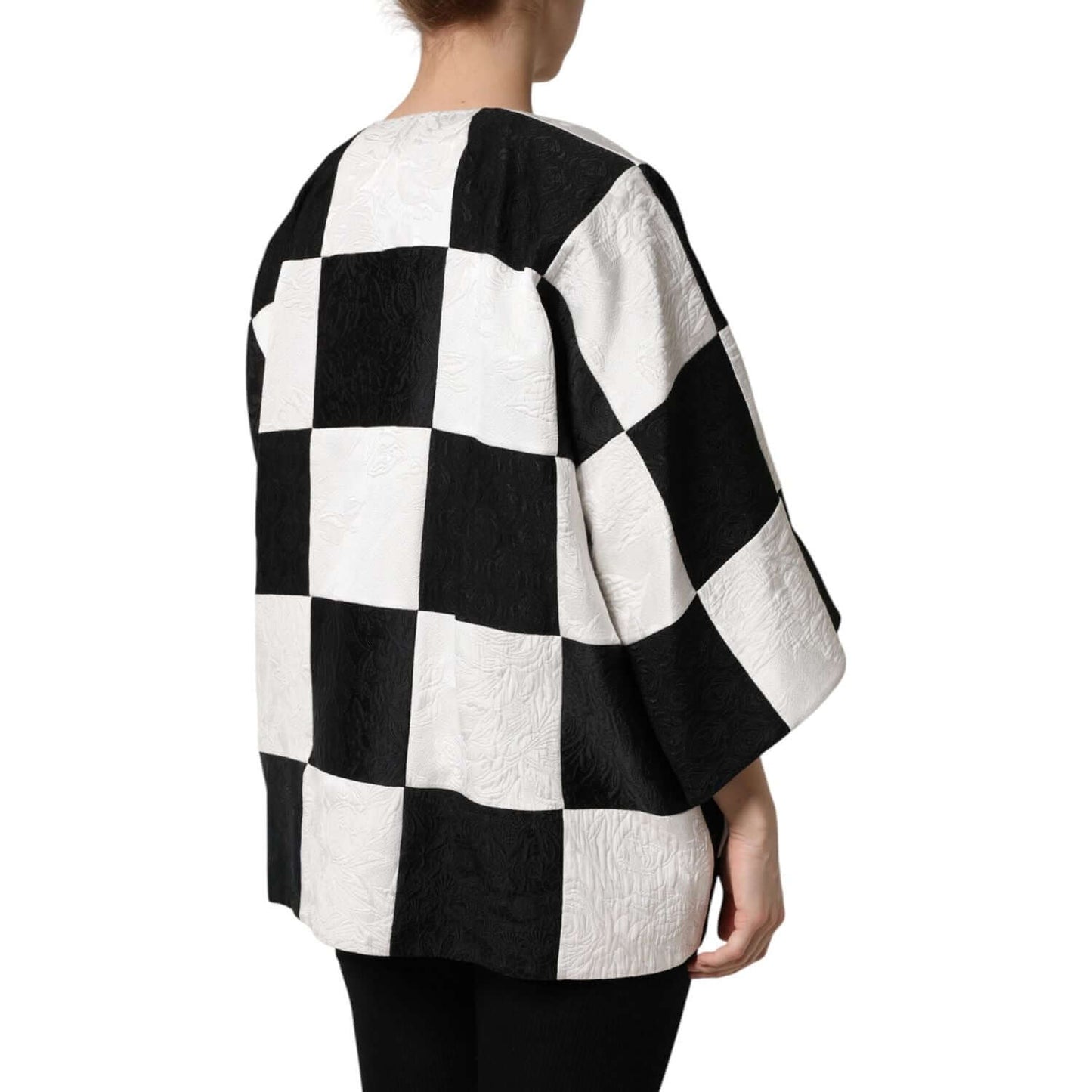 Dolce & Gabbana black and white checkered patchwork jacquard blazer jacket, rear view, worn by a model, highlighting oversized design.